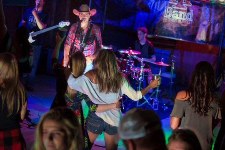 a group of people playing instruments and performing on a stage